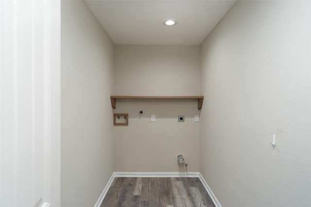 clothes washing area with electric dryer hookup, gas dryer hookup, hardwood / wood-style flooring, and washer hookup