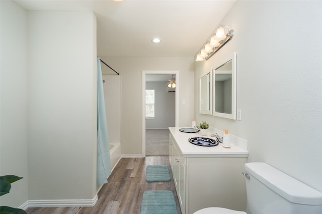 full bathroom featuring shower / bath combo, toilet, vanity, and hardwood / wood-style flooring