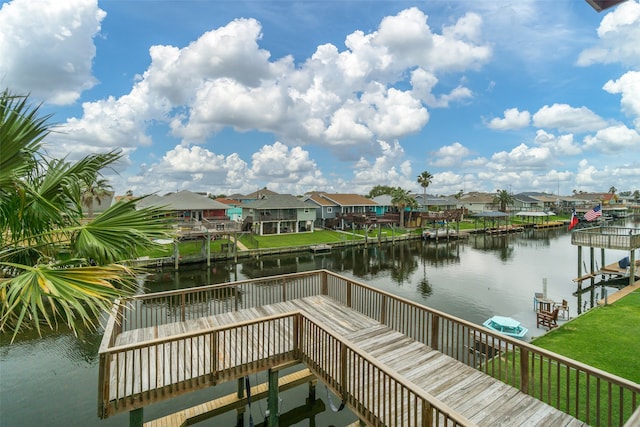 dock area featuring a yard and a water view