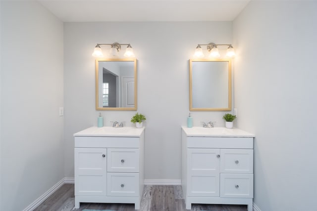 bathroom with hardwood / wood-style flooring, double sink, and oversized vanity