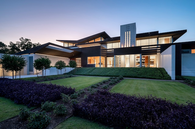 contemporary house with a garage and a lawn