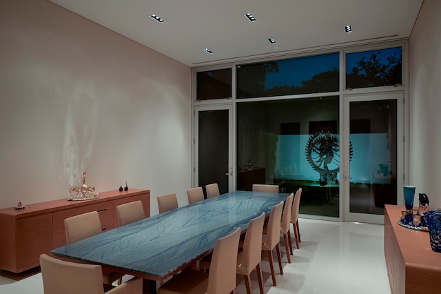 dining room featuring french doors, expansive windows, and light tile floors