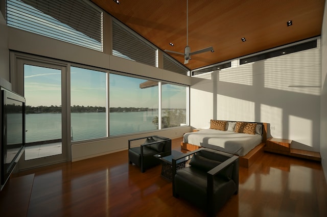 sunroom with a healthy amount of sunlight, ceiling fan, and a water view