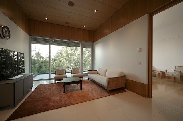 tiled living room featuring a towering ceiling