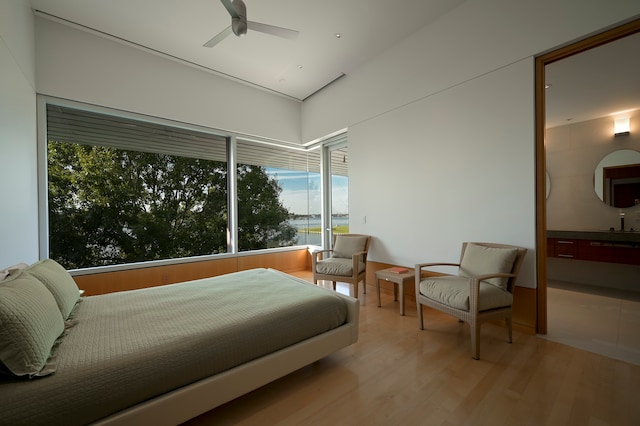 bedroom with ceiling fan and light wood-type flooring