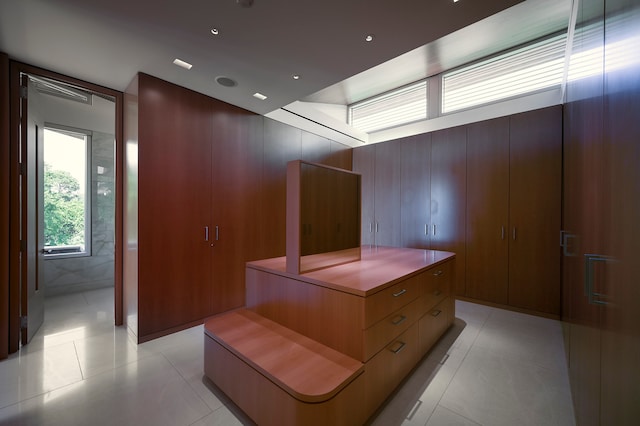 walk in closet featuring light tile flooring