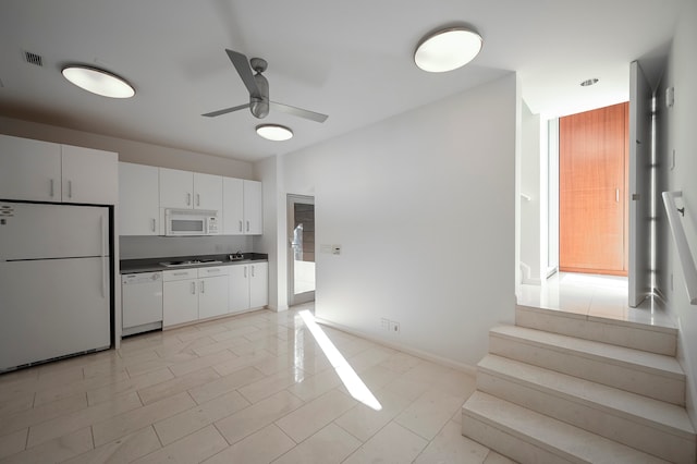 kitchen with white cabinets, ceiling fan, white appliances, and light tile floors