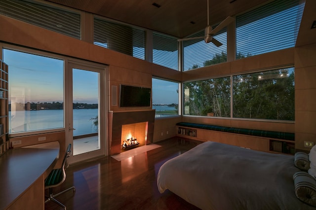 bedroom with a water view and a high ceiling