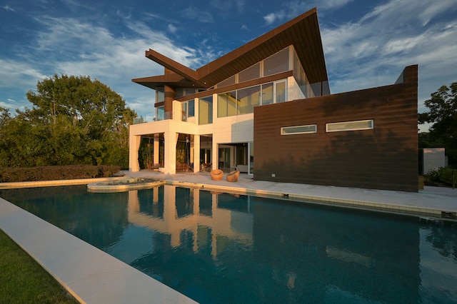 view of pool featuring a patio area and a jacuzzi