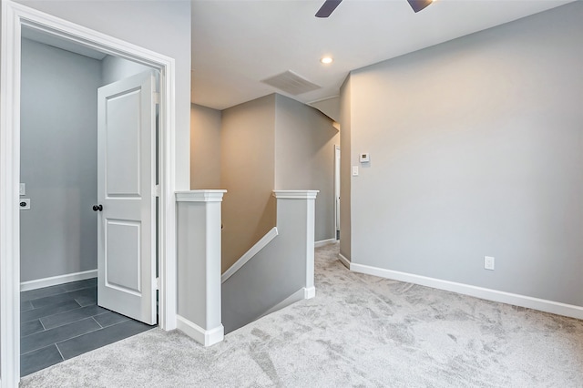 spare room with ceiling fan and carpet floors