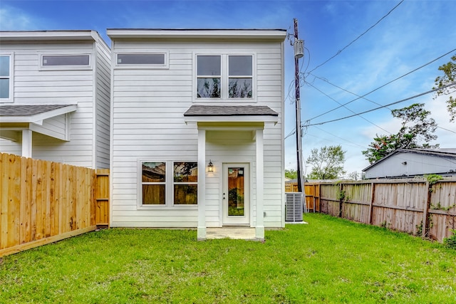 rear view of property with a lawn