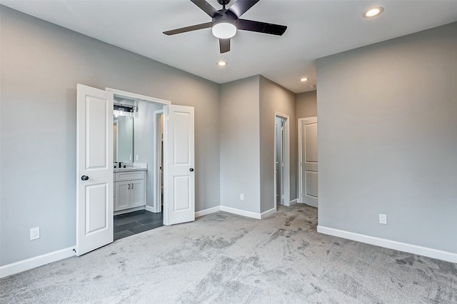 unfurnished bedroom featuring carpet flooring, ceiling fan, and ensuite bath