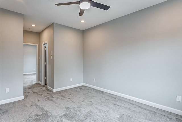 carpeted spare room with ceiling fan