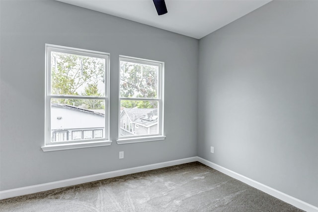 empty room with ceiling fan and carpet