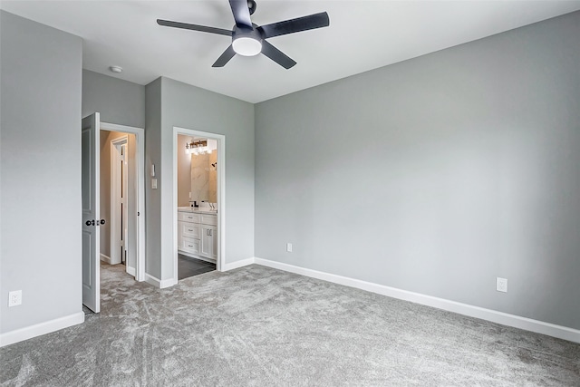 unfurnished bedroom with carpet flooring, connected bathroom, and ceiling fan