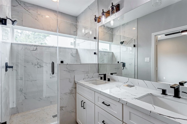 bathroom with vanity, a wealth of natural light, and a shower with door