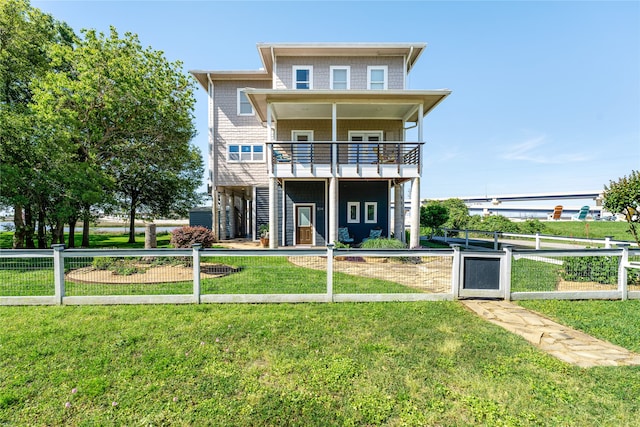 exterior space with a balcony and a front lawn