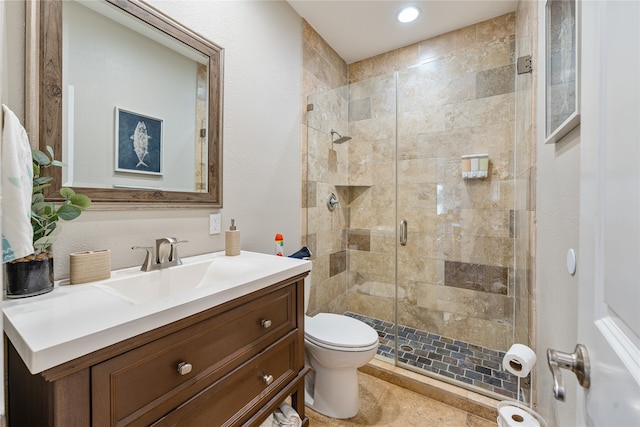 bathroom featuring vanity, toilet, tile patterned flooring, and walk in shower