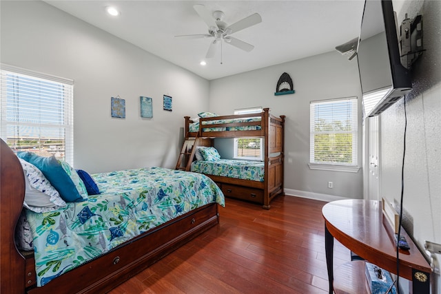 bedroom with dark hardwood / wood-style flooring and ceiling fan