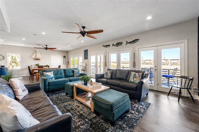 living room featuring french doors, ceiling fan, and a textured ceiling