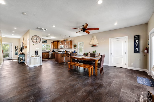 dining space featuring dark wood-type flooring and ceiling fan