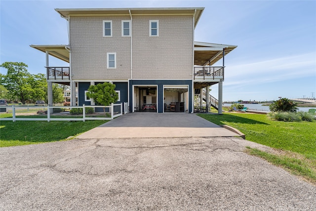 exterior space with a balcony and a front lawn