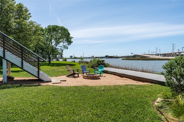 view of yard with a water view and an outdoor fire pit