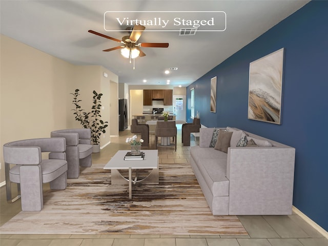 living room with ceiling fan and light wood-type flooring