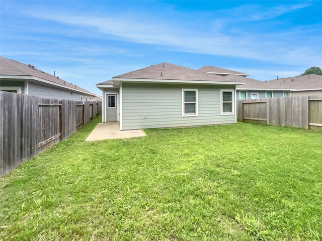 back of property featuring a patio and a lawn