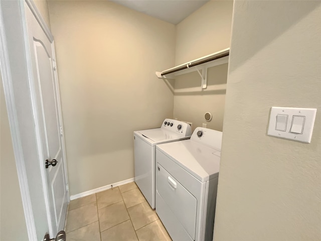 washroom with separate washer and dryer and light tile floors