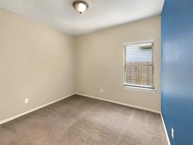 unfurnished room featuring dark carpet