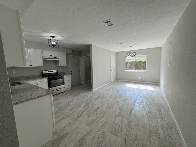 kitchen with gas range, a notable chandelier, stone counters, white cabinetry, and pendant lighting