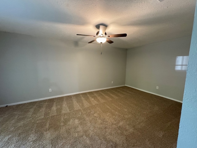 carpeted spare room with ceiling fan and a textured ceiling