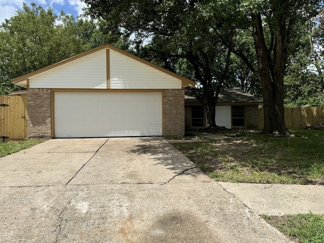 single story home with an outdoor structure and a garage