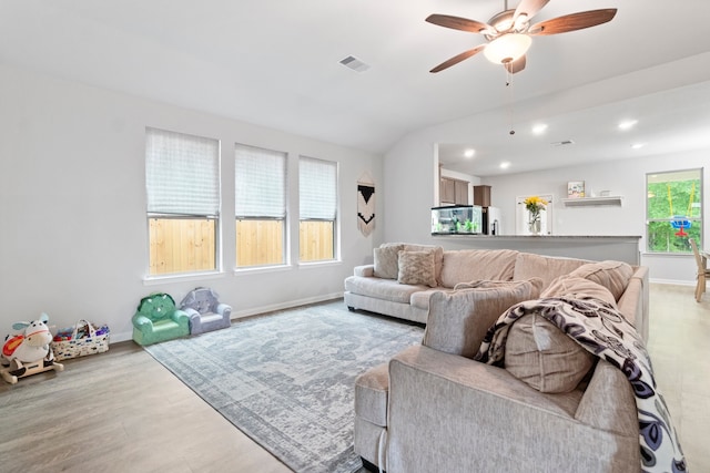 living room featuring light hardwood / wood-style floors and ceiling fan