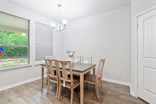 dining space featuring a notable chandelier and dark hardwood / wood-style floors