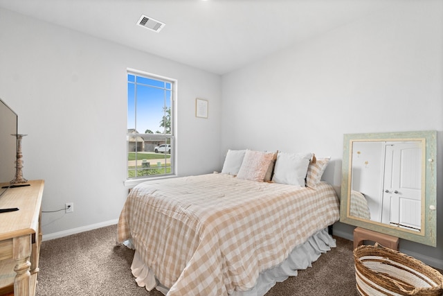 bedroom with dark colored carpet