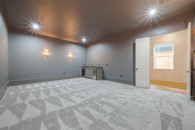 carpeted spare room featuring sink