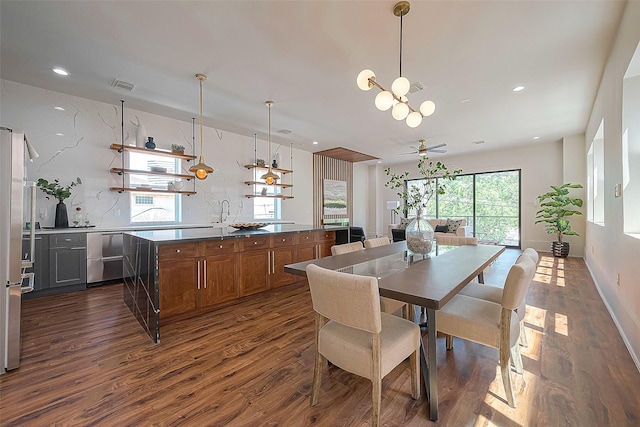 dining space with ceiling fan and dark wood-type flooring