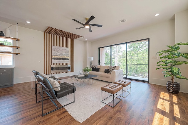 living room featuring dark hardwood / wood-style floors and ceiling fan