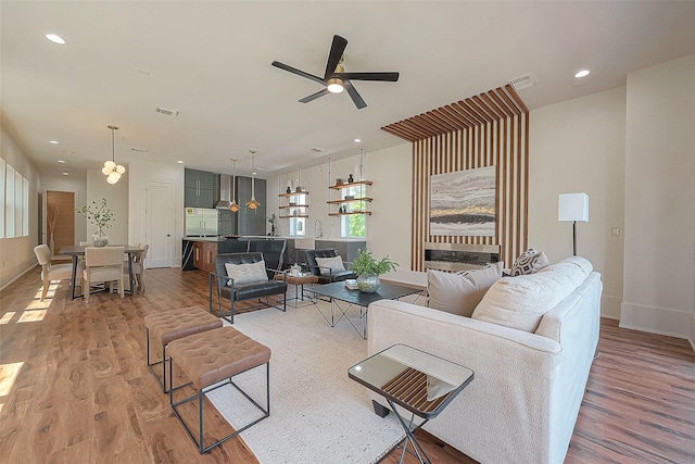 living room featuring hardwood / wood-style floors and ceiling fan