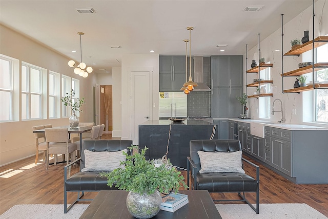 living room featuring light wood-type flooring and sink