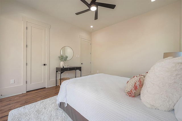 bedroom with ceiling fan and hardwood / wood-style flooring