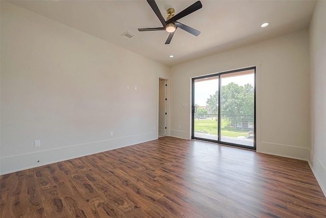 empty room with dark hardwood / wood-style floors and ceiling fan