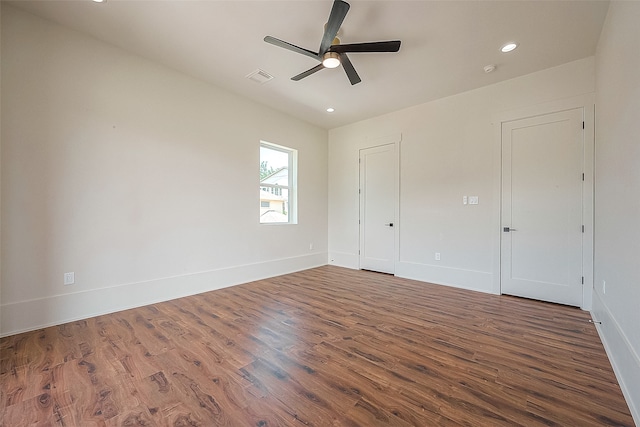 unfurnished room with dark hardwood / wood-style flooring and ceiling fan