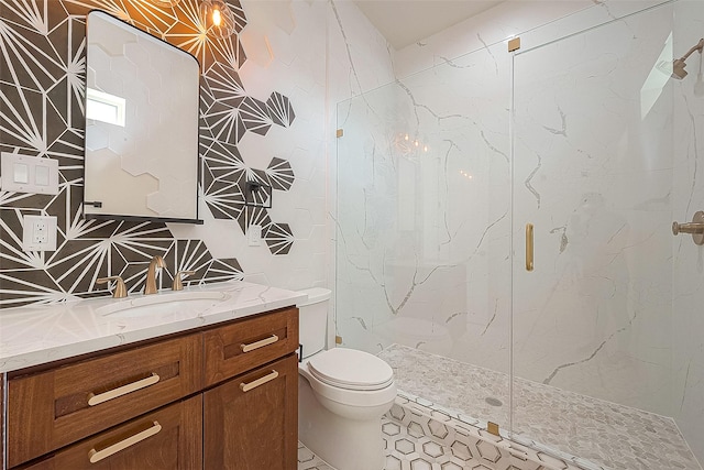 bathroom with tile patterned flooring, vanity, toilet, and a shower with shower door