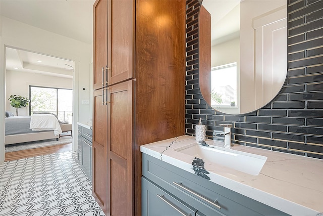 bathroom with vanity and tasteful backsplash