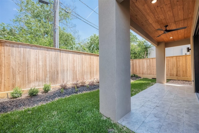 view of yard featuring ceiling fan and a patio area