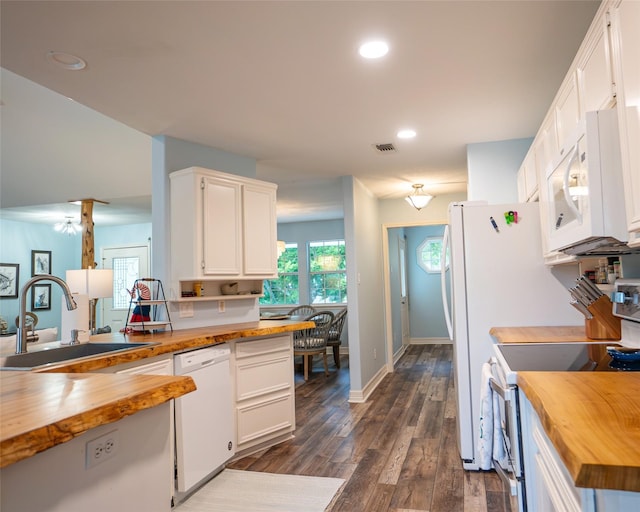 kitchen featuring white cabinets, butcher block countertops, white appliances, and sink