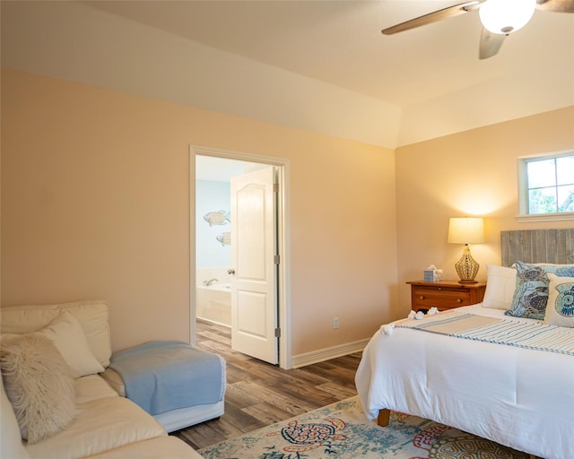 bedroom featuring hardwood / wood-style floors, ensuite bathroom, and ceiling fan